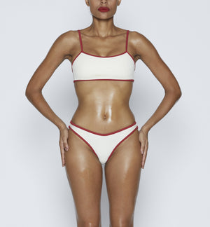 Swimwear Square neck bikini top in "Off White" color with " Red " contrast binding outline. Adjustable bikini straps. soft swimwear fabric. High legs bikini, high rise bikini bottom. Cheeky coverage swimwear bottom. Shop bikini online.