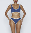 Swimwear Top. Pullover bikini sport bra style top  in dark Blue with Off White contrast binding outline. Bikini bottom. Mid to High Waisted Swimwear bottom in Dark Blue with Off White. Medium to full coverage bikini bottom. High Legs swimsuit bottom. Check out our fashion boutique swimsuit online shop.