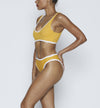 Swimwear Top. Pullover bikini sport bra style top  in vintage yellow with White contrast binding outline. Bikini bottom. Mid to High Waisted Swimwear bottom in yellow vintage with White binding outline. Medium to full coverage bikini bottom. High Legs swimsuit bottom. Check out our fashion boutique swimsuit online shop. supper soft fabric Nylon/spandex. sport bikini