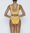 Swimwear Top. Pullover bikini sport bra style top  in vintage yellow with White contrast binding outline. Bikini bottom. Mid to High Waisted Swimwear bottom in yellow vintage with White binding outline. Medium to full coverage bikini bottom. High Legs swimsuit bottom. Check out our fashion boutique swimsuit online shop. supper soft fabric Nylon/spandex. sport bikini