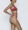 Swimwear Top. Pullover bikini sport bra style top  in ruby red with White contrast binding outline. Bikini bottom. Mid to High Waisted Swimwear bottom in ruby red with White. Medium to full coverage bikini bottom. High Legs swimsuit bottom. Check out our fashion boutique swimsuit online shop. supper soft fabric Nylon/spandex. sport bikini